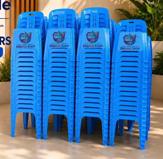 Four tall stacks of blue plastic chairs with slotted backs