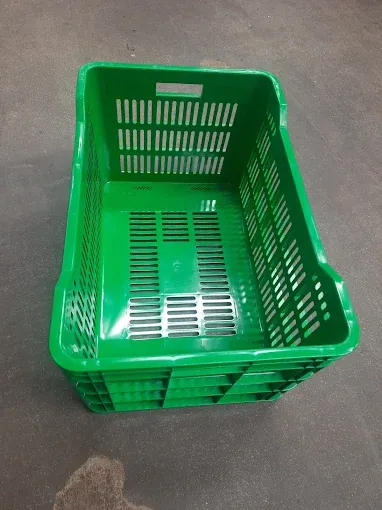Green rectangular plastic basket with slotted sides and base