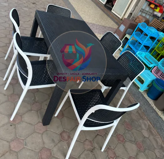 Black outdoor plastic table with white-framed chairs at Des fair shop, Arua Park, Kampala
